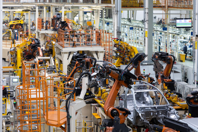 Car bodies are on assembly line. Factory for production of cars. Modern automotive industry. Electric car factory, conveyor.